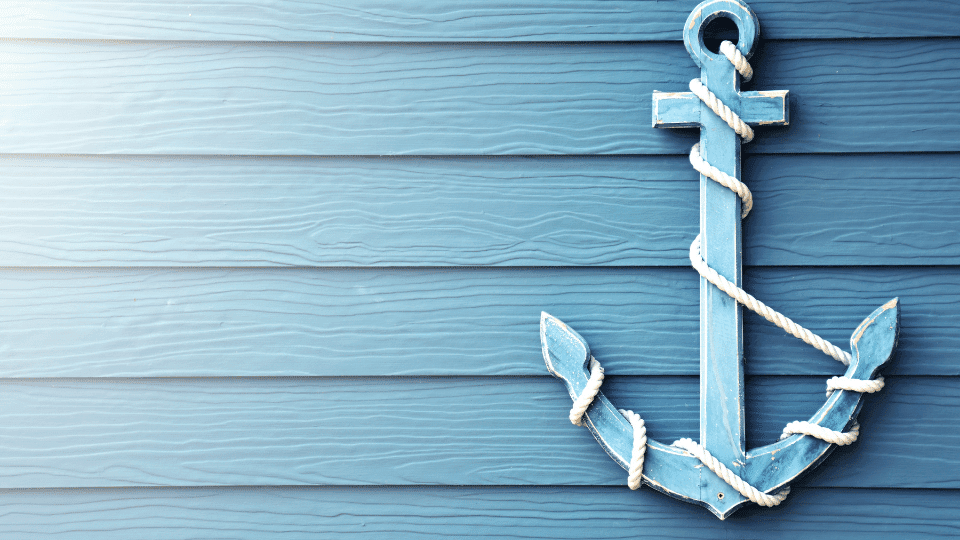 a blue anchor with white rope on a blue wall